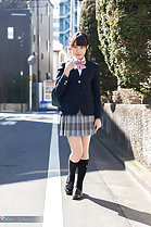 Student walking along road in uniform