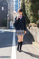 Student walking along road in uniform