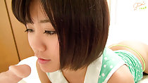 Lying on bed short hair looking at dildo