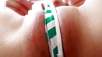 Striped thong panties pulled tight over her shaved pussy