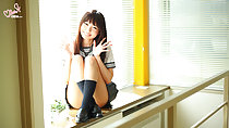 Minami H seated beside window in classrroom wearing kogal uniform long hair legs raised
