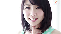 Finger raised under her chin