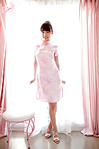 Standing in front of window wearing pink cheongsam high heels
