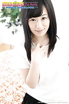 Yui Kyono with her long hair framing her face fingers playing idly with her top