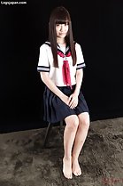 Kogal seated hands clasped bare feet