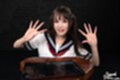Kurumi ria kneeling wearing uniform hands raised cum on her hands
