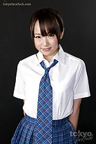 Student Mizushima Ai standing in uniform hands behind back school tie