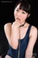 Fingers in her mouth wearing blue swimsuit bondage chain