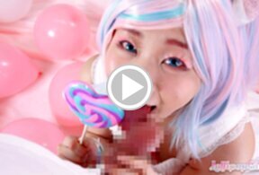 Minano Ai on her knees licking lollipop and sucking cock